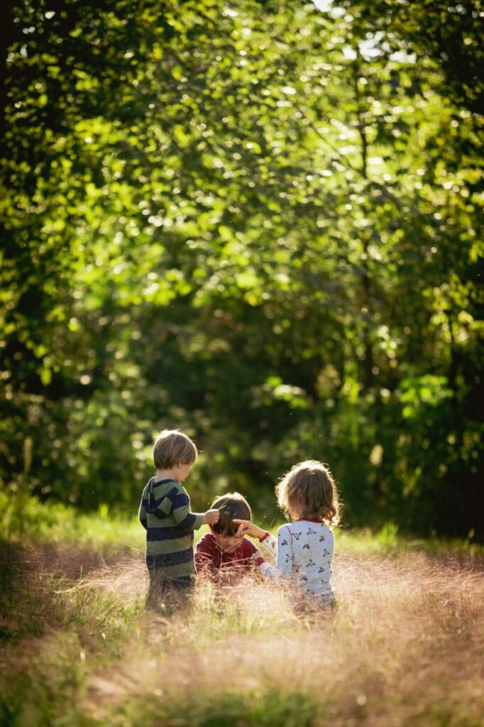 Family vacation planner with children playing in a sunlit field.